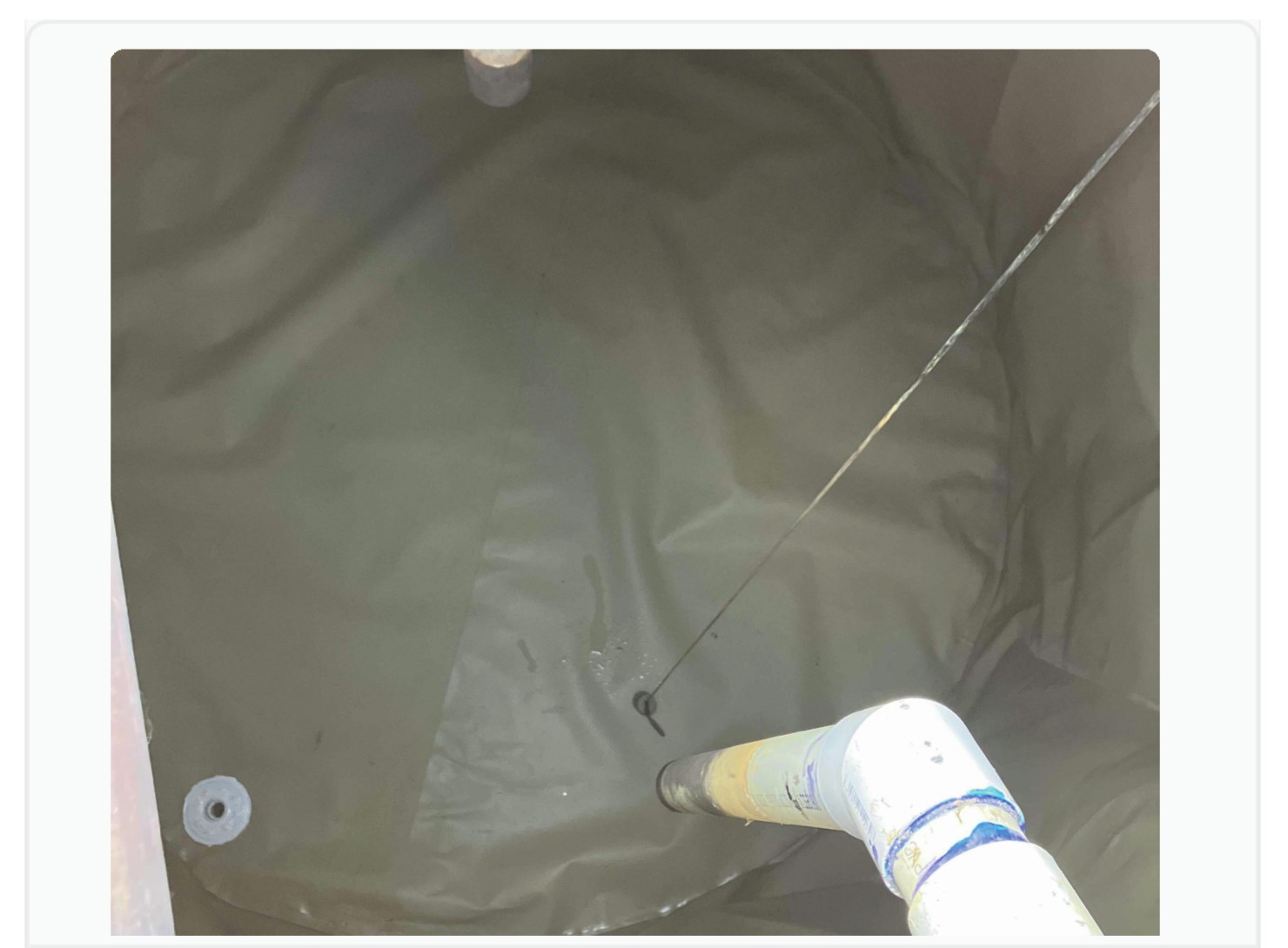Submersible pressure transducer installed inside a rainwater storage bladder tank