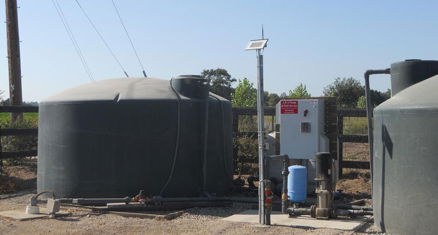 Water tanks with a solar-powered Ranch Systems monitoring node